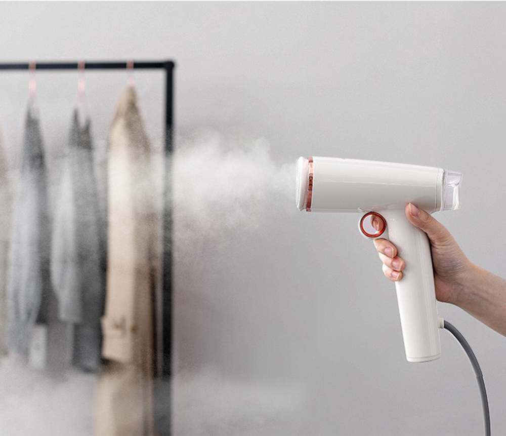 Hand held ironing machine